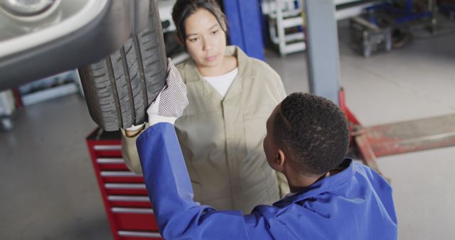 Auto Mechanics Inspecting Tire in Repair Shop - Download Free Stock Images Pikwizard.com