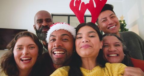 Diverse Group of Friends Celebrating Christmas Together with Laughter