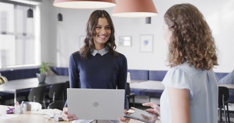 Diverse Female Colleagues Engaging in Teamwork at Modern Office