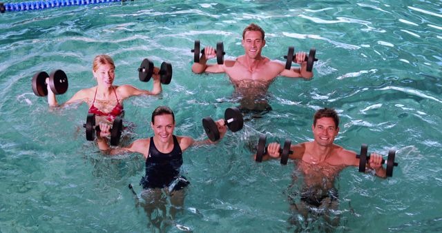 Group of adults performing water aerobics with dumbbells in a swimming pool. Ideal for advertisements, fitness class promotions, health and wellness content, and active lifestyle magazines.