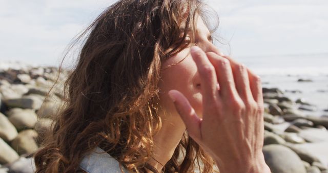 Woman Enjoying Fresh Air by Rocky Seaside, Wind Blowing Hair - Download Free Stock Images Pikwizard.com