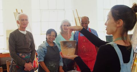 Diverse seniors enjoying creative pottery class experience