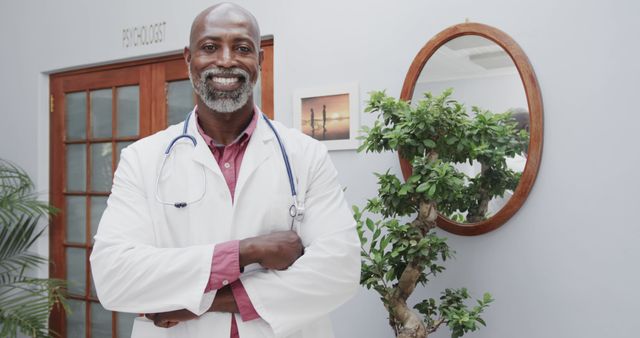 Confident African American Doctor Standing with Arms Crossed in Office - Download Free Stock Images Pikwizard.com