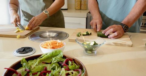 Diverse Senior Couple Preparing Healthy Meal in Modern Kitchen