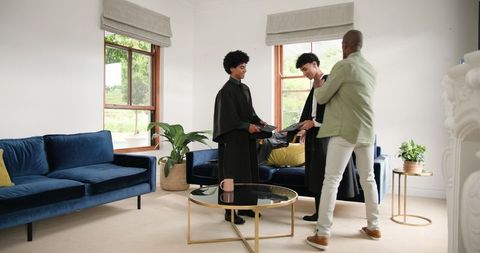 Proud Photoshoot of Milestone, Father Elevating Sons for School Triumph at Sweet Home Celebration