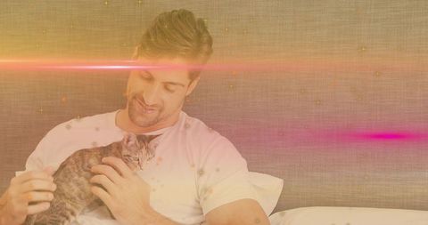 Man Relaxing with Kitten and Warm Sparkle Glow