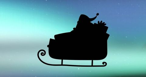 Santa Silhouette in Sleigh with Gifts Against Aurora Sky
