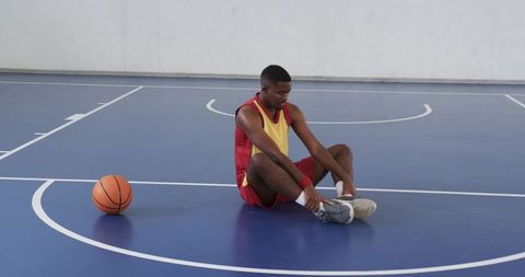 Athlete Stretching on Basketball Court