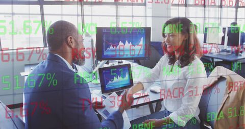 Diverse Business Professionals Analyzing Graphs in Office