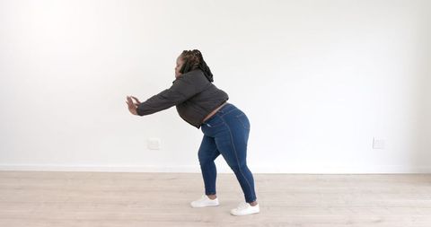 Woman Stretching Indoors for Fitness Preparation