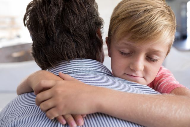 Father and son embracing each other in living room - Download Free Stock Photos Pikwizard.com