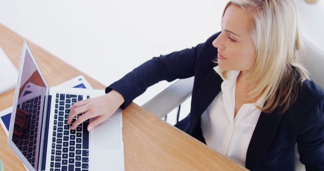 Businesswoman Working on Laptop at Desk - Download Free Stock Images Pikwizard.com