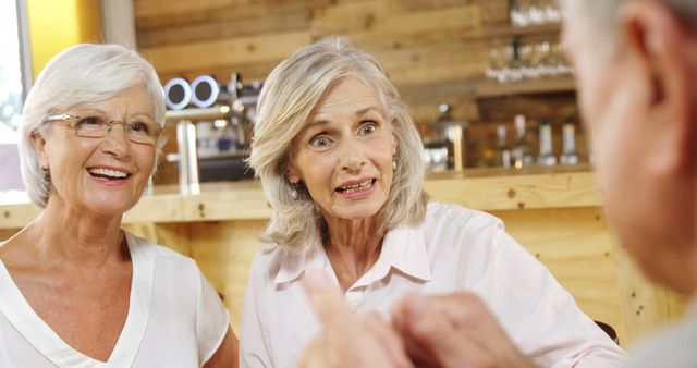 Senior Friends Engaging in Enthusiastic Conversation at Café - Download Free Stock Images Pikwizard.com