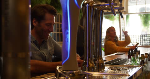 Relaxed Couple Enjoying Drinks at Hotel Bar, Ly Security Filter