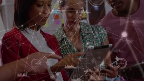 Diverse Colleagues Collaborating with Digital Tablet in Office