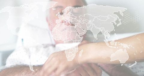 Holding senior patient forearm providing comfort for global health care with map overlay