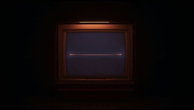Moody retro CRT television glowing with thin orange-pink scanline on dark wooden bezel