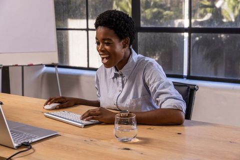 Professional African American Woman Typing Comfortably in Office Environment