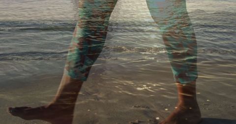 Double exposure of man walking beach and ocean waves
