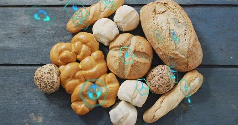 Artisanal bread flatlay showcasing challah baguettes seeded rolls with cyan hex overlays
