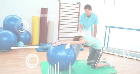 Kneeling woman leaning over blue stability ball with trainer guiding rehab and posture