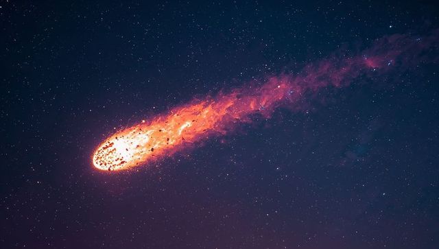 Racing fireball meteor blazing across starry night sky with fiery plasma trail and debris