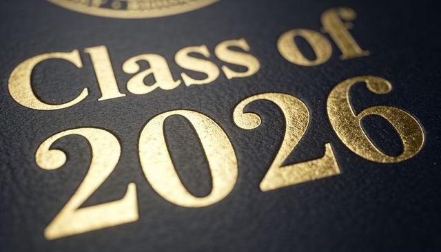 Displaying class of 2026 gold-foil embossed diploma cover closeup, macro texture
