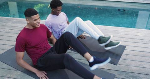 Diverse friends exercising by poolside featuring core workout routine