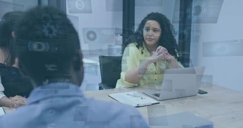 Leading businesswoman guiding boardroom meeting with laptop, team discussion, leadership