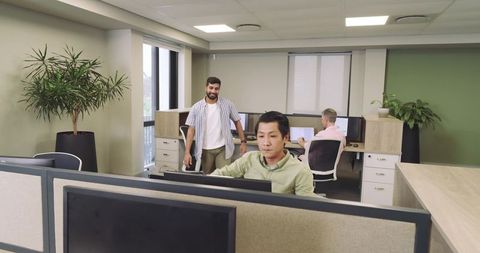 Diverse coworkers collaborating in a modern open plan office setting