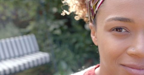 Joyful Young Black Woman Smiling Outdoors in Garden