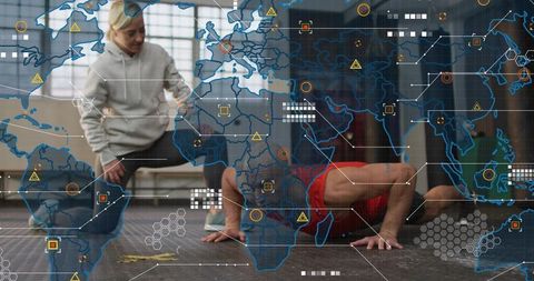 Coach guiding athlete performing pushup in industrial gym with futuristic data overlay