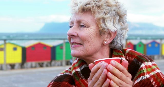 Senior Woman Enjoying Hot Drink on Seafront - Download Free Stock Images Pikwizard.com