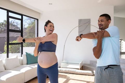 Diverse active women practicing arm stretches indoors for a healthy lifestyle