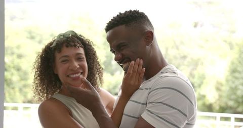 Joyful Couple Bonding Outdoors in Warm sunlight