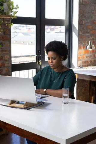 Confident Professional Woman Working in Modern Office Loft