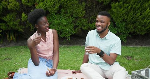 Couple Enjoying Relaxing Picnic Outdoors With Refreshing Lemonade