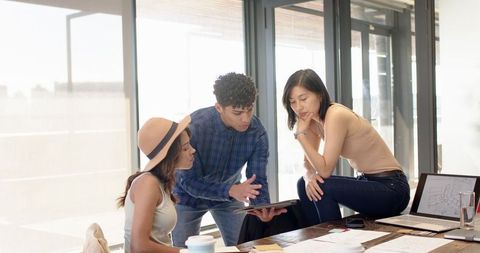 Diverse Team Collaborating on Project in Sunlit Office