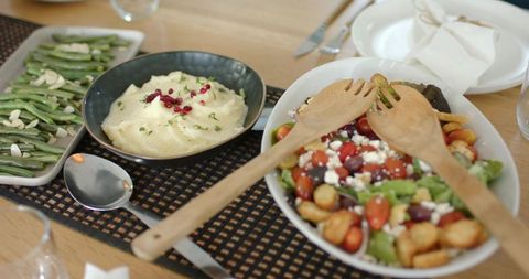 Family-style mediterranean salad with cherry tomatoes, feta, olives and mashed potatoes