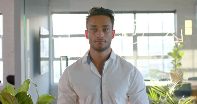 Confident Young Professional in White Shirt Standing in Modern Office - Download Free Stock Images Pikwizard.com