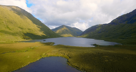 Transparent Tranquility: Serene Lake and Majestic Mountainscape