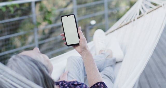 Person Relaxing on Hammock Using Smartphone Outdoors - Download Free Stock Images Pikwizard.com