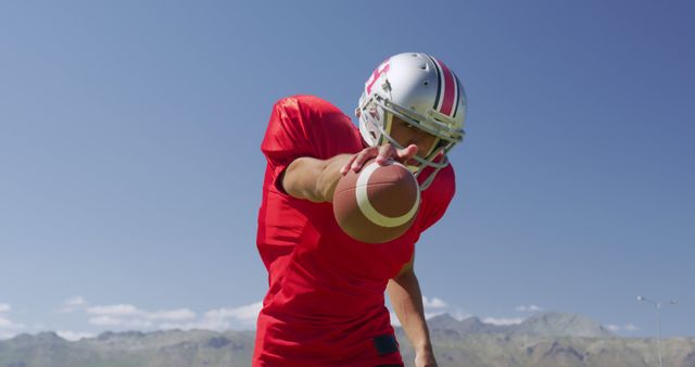 American Football Player Reaching Out with Ball Outdoors - Download Free Stock Images Pikwizard.com