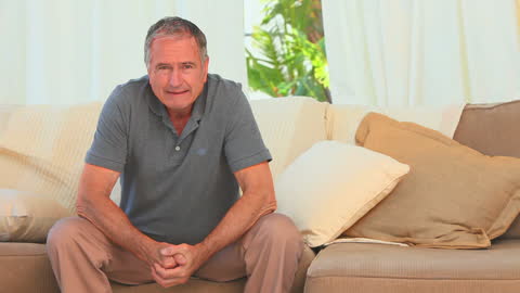 Middle-Aged Man Contemplating Life on Comfortable Couch