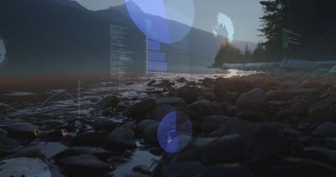 Dawn light reflecting on wet pebble shore with digital overlay and coastal forest