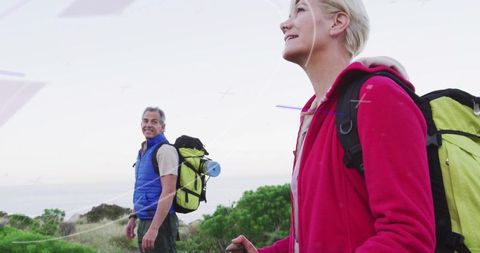 Active mature couple hiking beautiful coastal trail