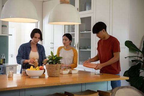 Diverse Family Bonding in Modern Kitchen While Cooking a Meal