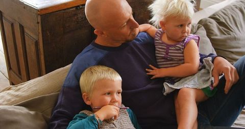 Father Spends Quality Time with Children on Living Room Sofa
