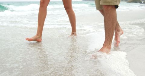 Romantic Couple Walking Barefoot Along Scenic Beach Shore - Download Free Stock Images Pikwizard.com