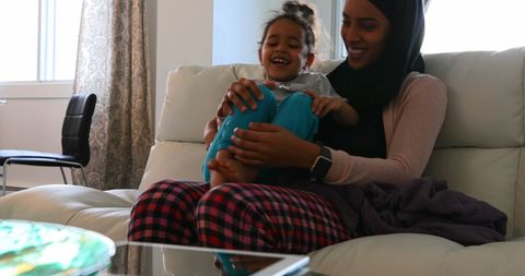 Joyful Mother and Child Relaxing Together on a Cozy Sofa